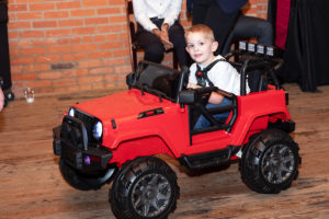 Go Baby Go patient in a mobility assistance vehicle